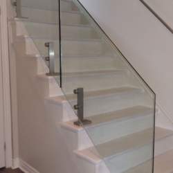 second floor staircase with glass railings