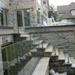 outdoor staircase with frameless glass railings